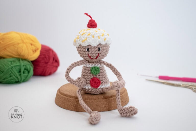 Crochet posable Gingerbread man Christmas ornament free pattern posing on a white background