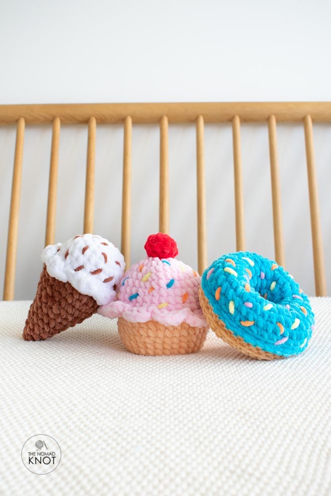 Crochet food amigurumi – cupcake, ice cream, and donut plush toys on a bed