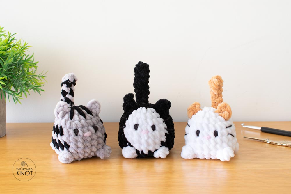 three chubby crochet plush cats called little chonkers on top of a table. Free amigurumi cat pattern