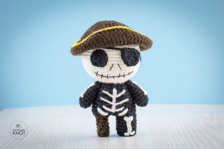 Crochet Pirate Jack Skeleton free pattern on top of a white shelf and blue background